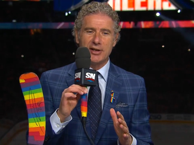 Gene Principe shows support of Oilers’ Pride Night with Pride Tape on microphone