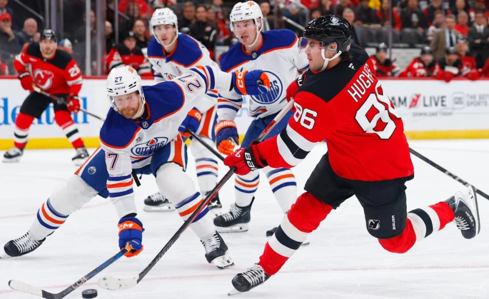Hughes scores two goals as Devils beat Oilers