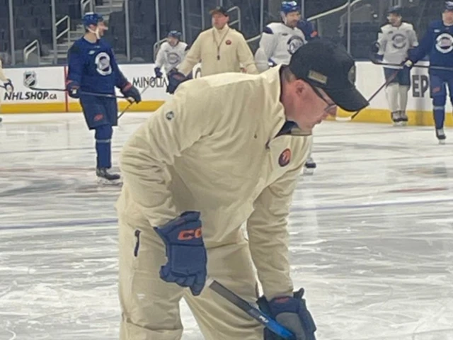 Edmonton Oilers coaches wearing ridiculous third-jersey themed tracksuits
